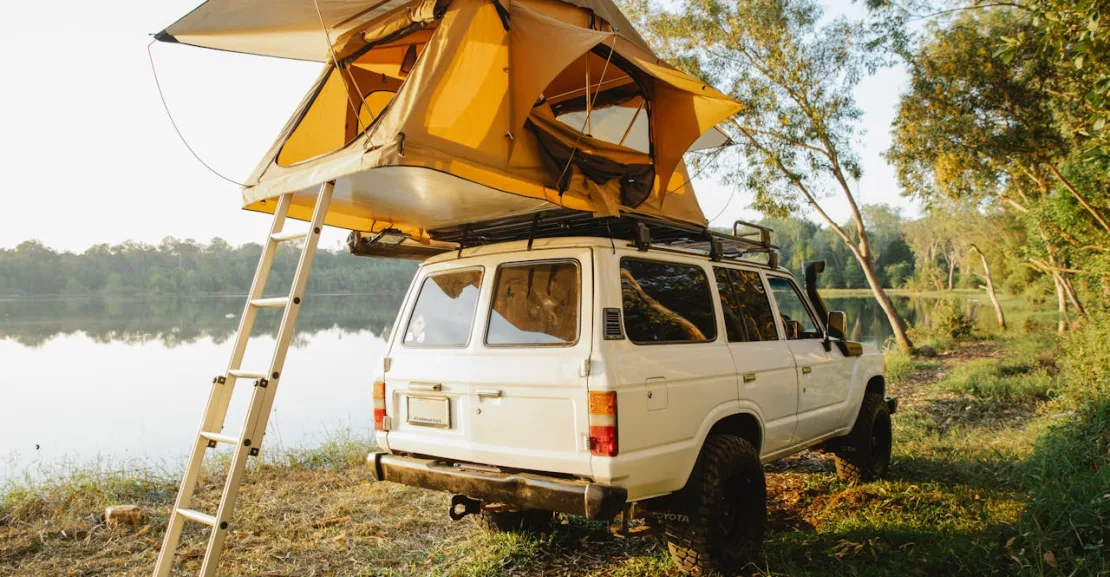 a white SUV beside a lake to talk about the best suv for camping​